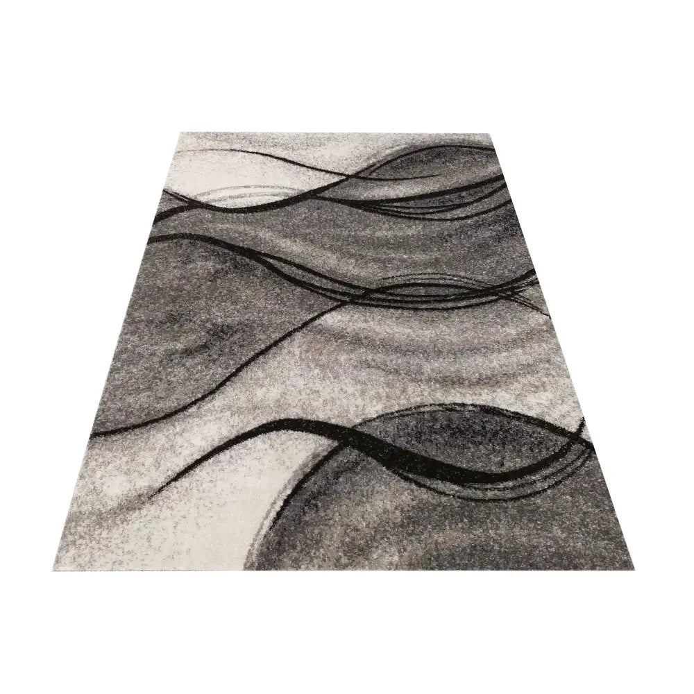 Grå Panamero 07 Tepe 240x330 cm, skrått sett teppe med abstrakte svarte linjer og varierende grå nyanser.