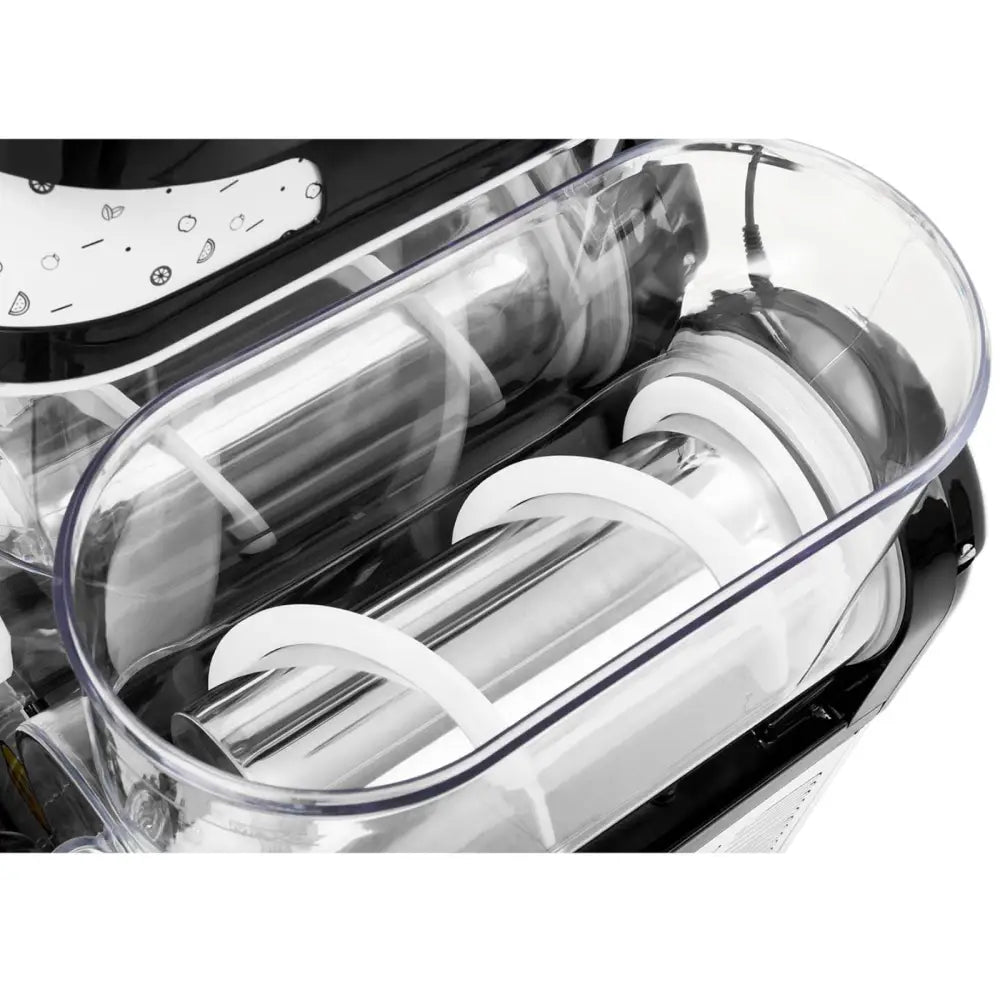 Granitor tre-slusjemaskin, nærbilde ovenfra av beholder og innsidemekanisme med valser og rører.