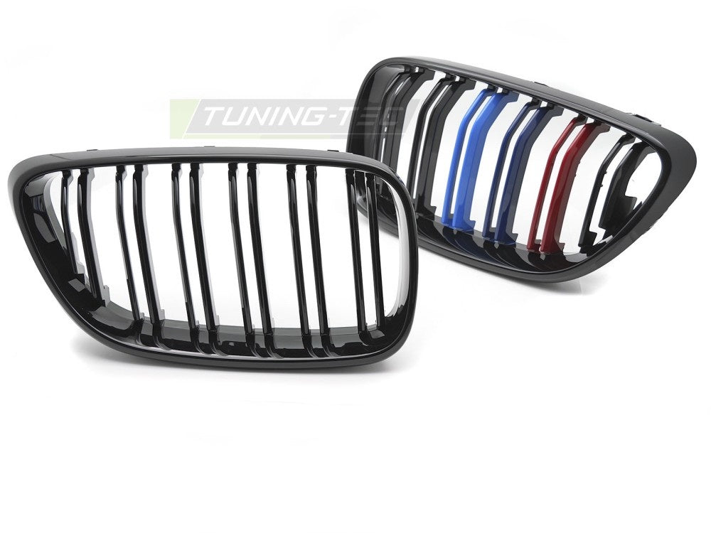 Nærbilde av tri-colour detaljer på svart dobbeltribbe-grill til BMW F22/F23