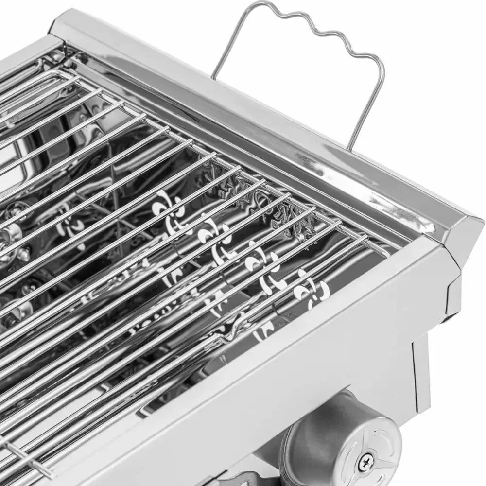Grillbærbar kullgrill i stål, nærbilde av gitterrist, håndtak og justeringsknapp sett fra skrå vinkel.