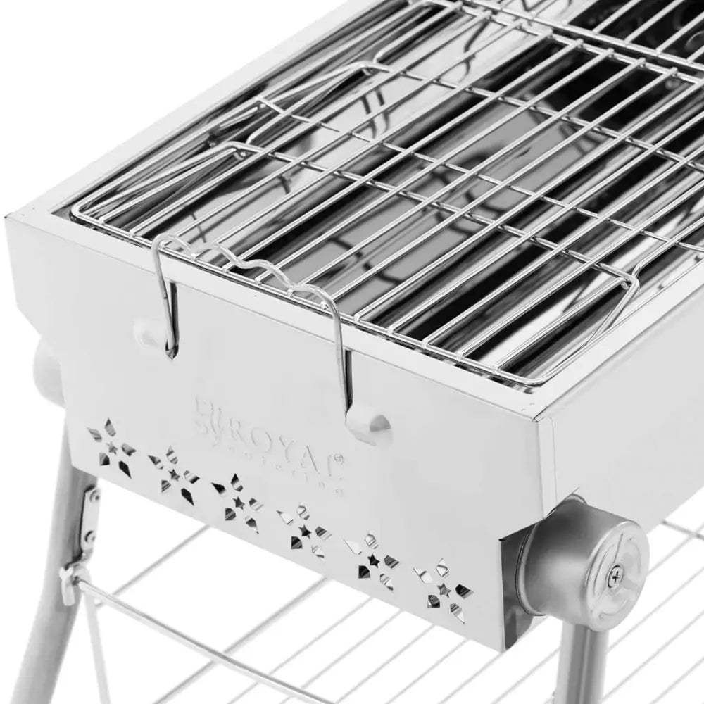 Grillkull med sammenleggbar rist, sidevisning som fremhever stjerneformede luftehull og dreiehjul på grillen.