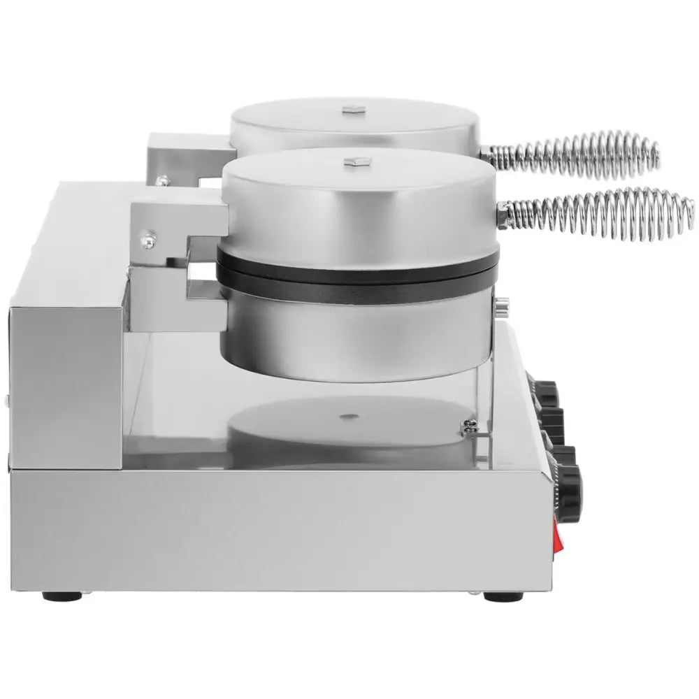 Hjerteformet dobbelt vaffeljern med spiralhåndtak og svarte kontrollknapper, sett fra siden.