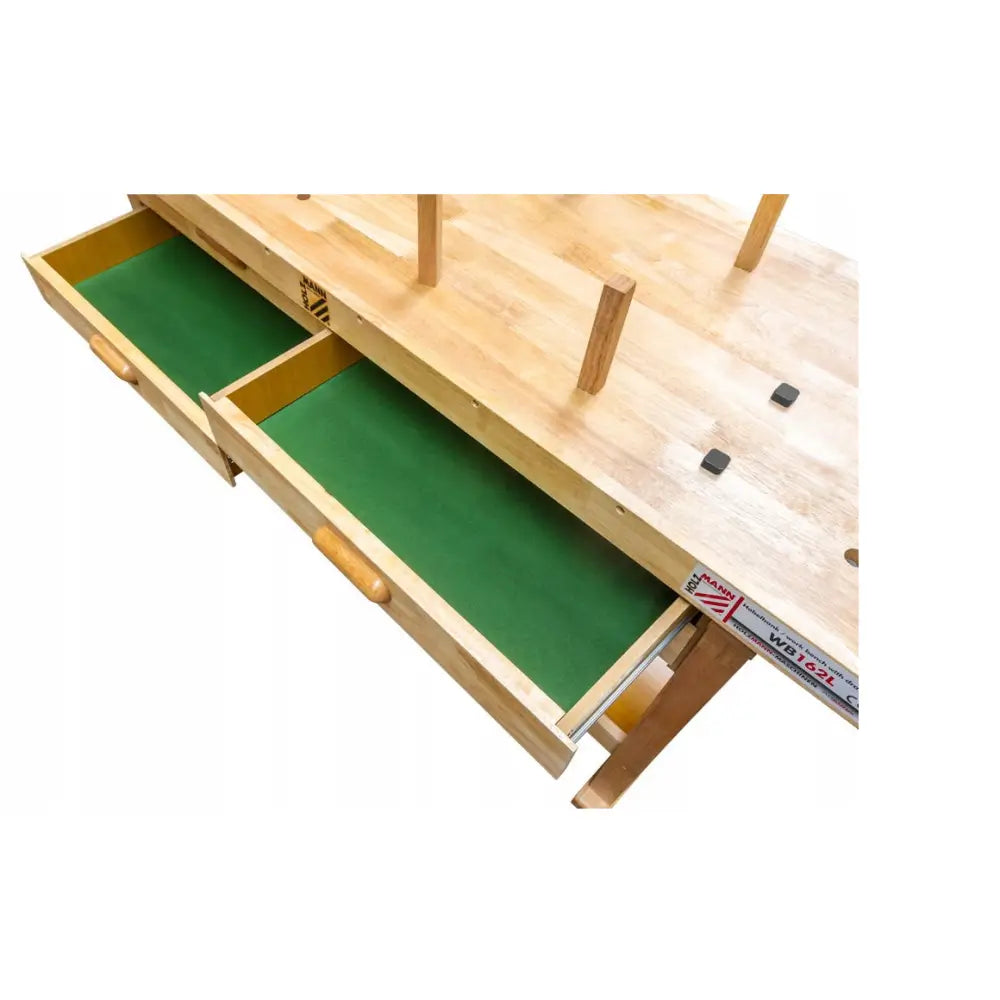 Høvelbenk i lyst tre med to åpne skuffer og grønne innvendige flater, sett skrått ovenfra.