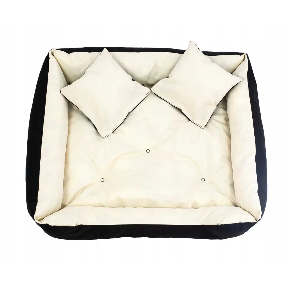 Hundeseng Sofa for Hund og Katt, rektangulær med svarte kanter, kremfarget polstring og to matchende puter, sett ovenfra.