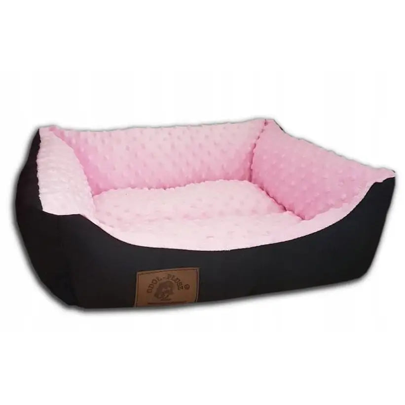 Hundeseng Sofa for Hunden Katten York, skråvisning som fremhever svart kant, rosa prikket innside og synlig logo foran.