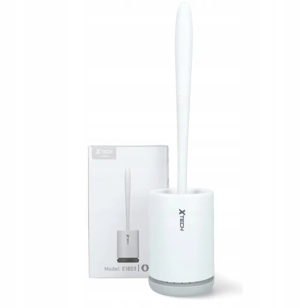 Hvit silikon toalettbørste med sylinderformet holder, plassert foran emballasjen med identisk design.