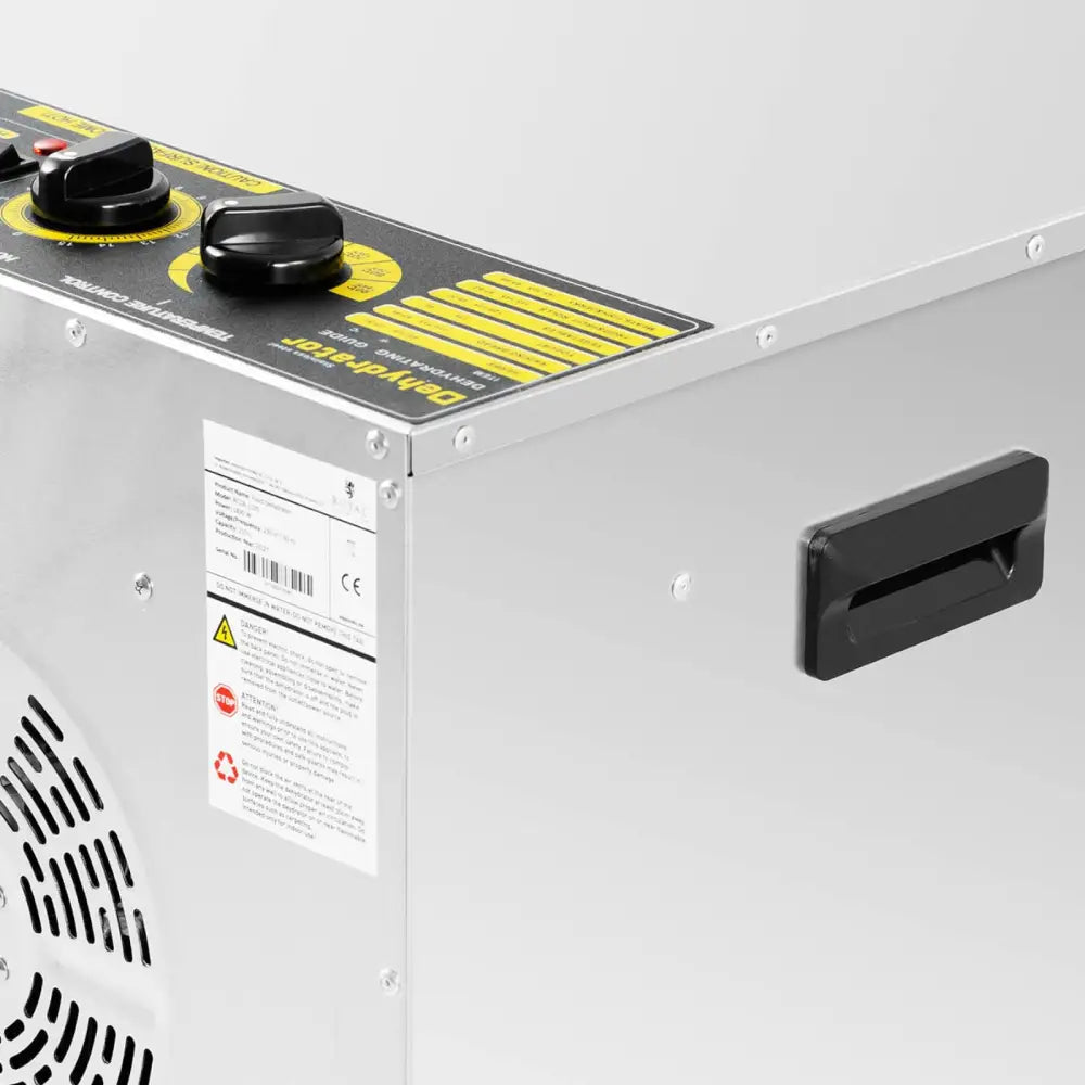 Industriell tørketrommel for mat, urter og grønnsaker med synlige brytere, etiketter og sort håndtak.