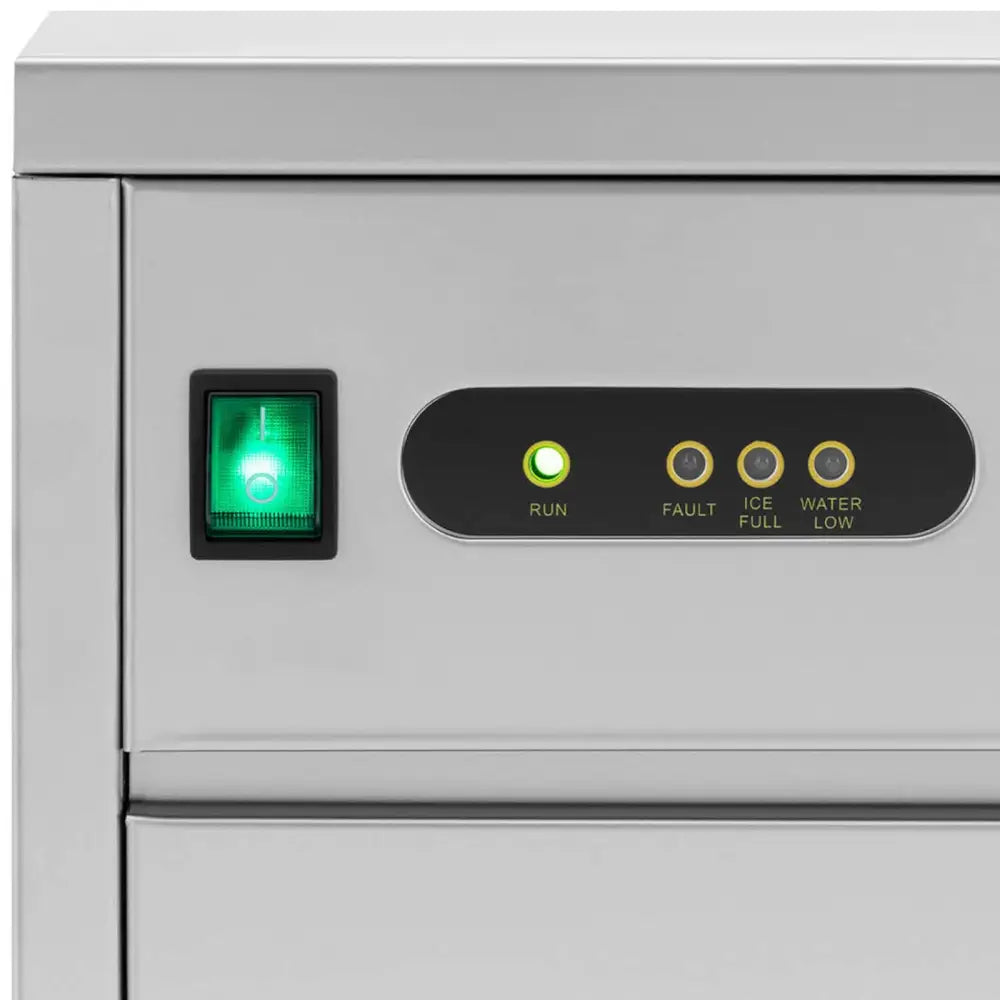 Ismaskin for barer, nærbilde av kontrollpanel med grønn av/på-bryter og fire tydelige indikatorlamper.