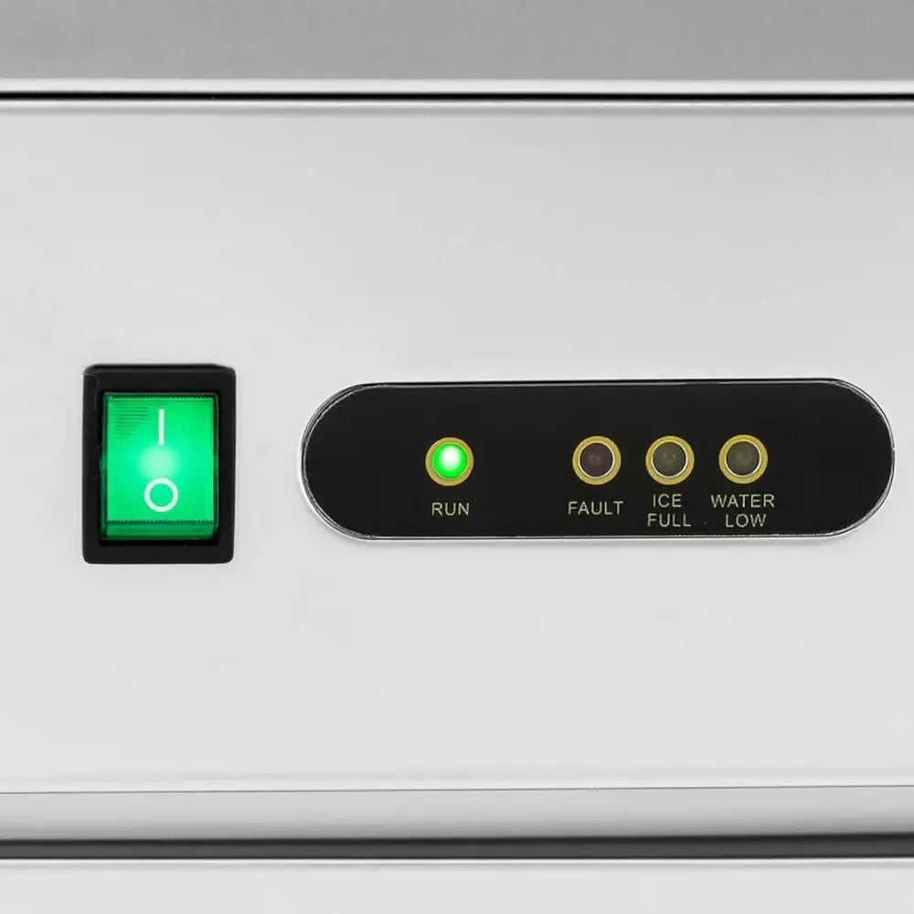 Ismaskin for barer, nærbilde av kontrollpanel med grønn bryter og fire tydelige indikatorlamper på sølvfarget panel.