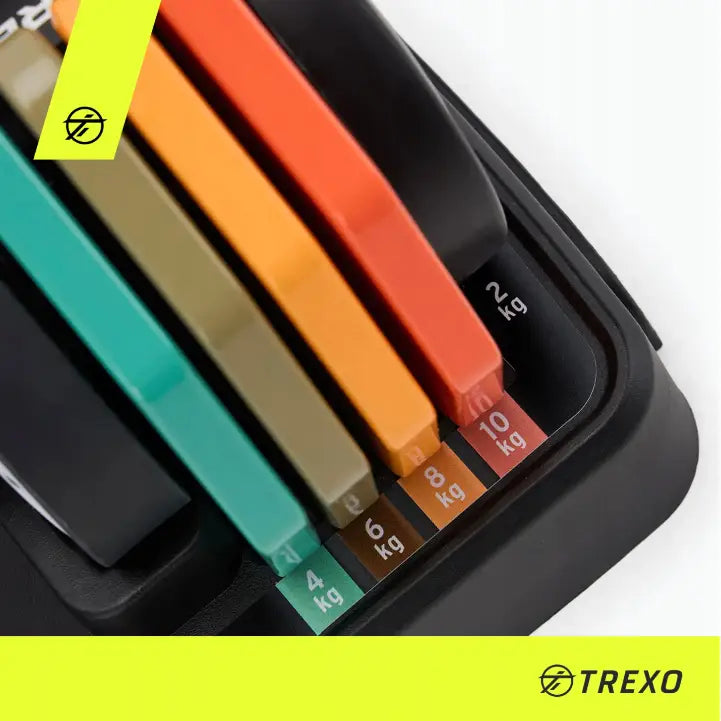 Justerbare manualer Trexo, nærbilde av fargerike vektmarkeringer fra 2 til 10 kg på sort base.