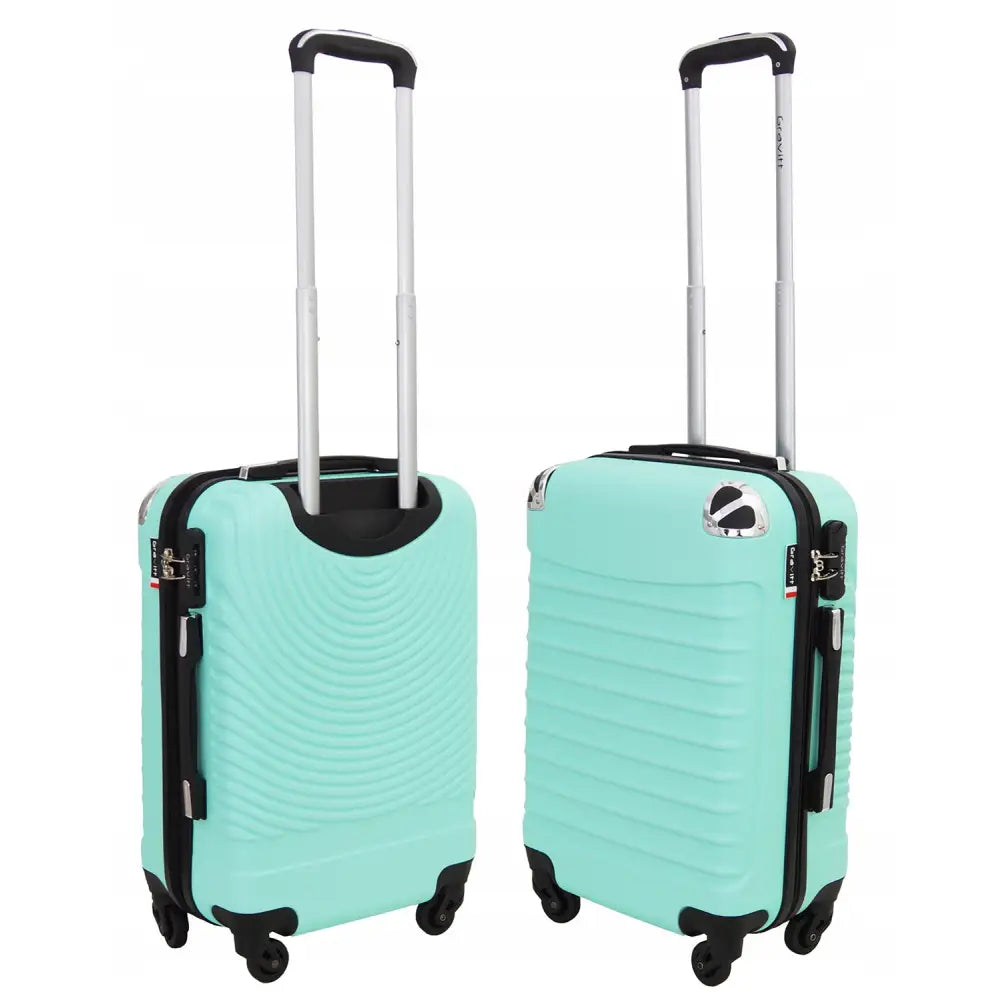 Kabintrillekoffert Gravitt, to turkise hardplastkofferter med fire hjul og sølv teleskophåndtak, skrå vinkel.