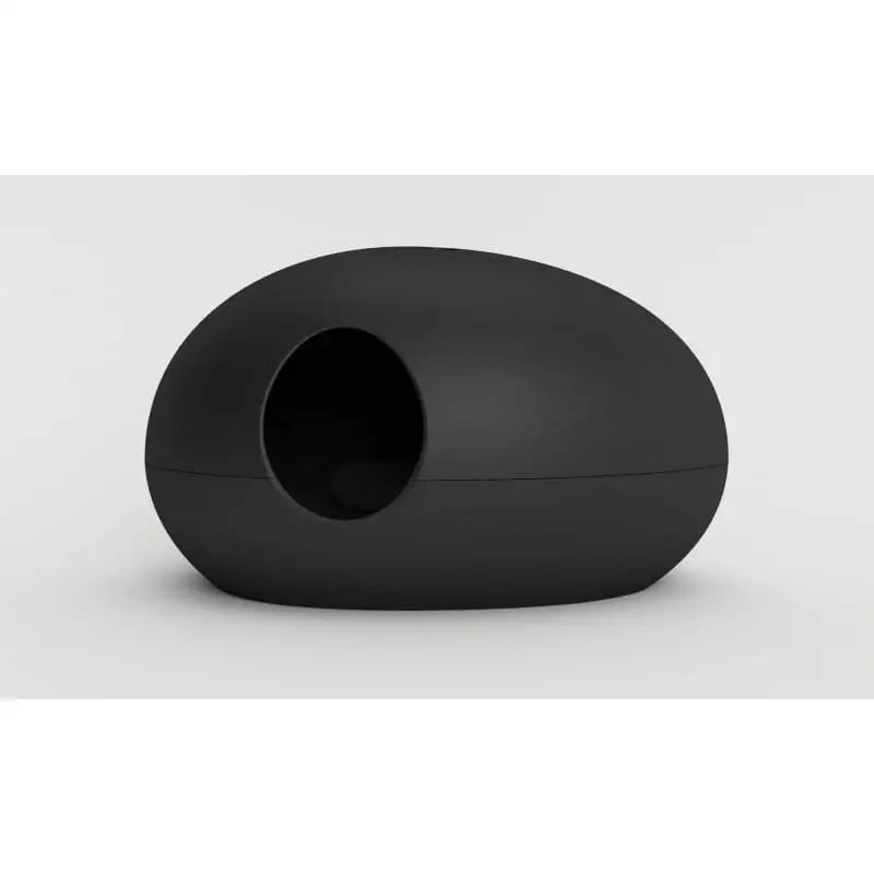 Kattetoalett Poopoopeedo i svart hardplast, oval sideprofil med rund inngang åpning, plassert på lyst underlag.
