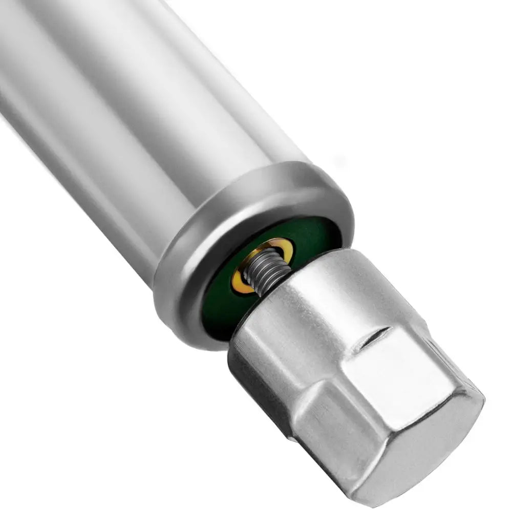 Kjøkkenbord Rustfritt Stål, nærbilde av metallben med synlig gjenge, mutter og grønn-gul detalj.