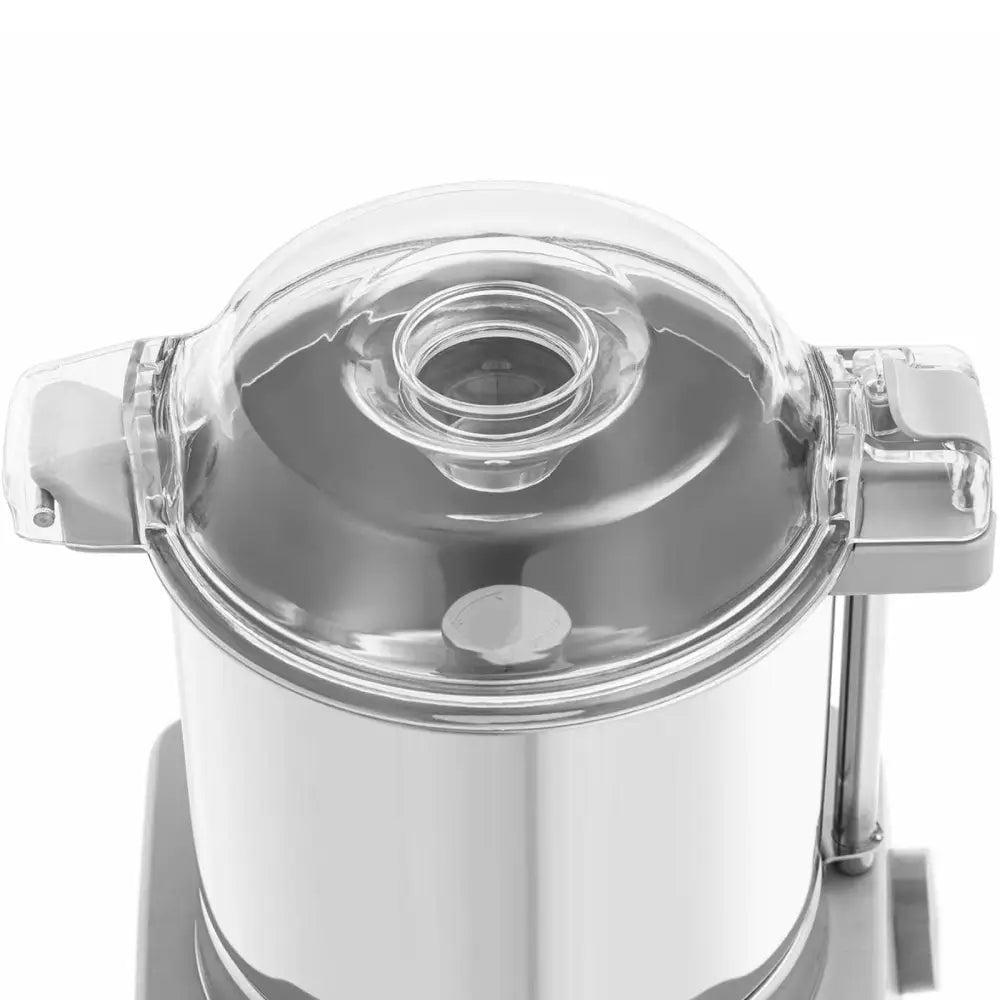 Kjøkkenhakker med transparent lokk, rund åpning og synlige hengsler på metallbeholder, sett ovenfra.