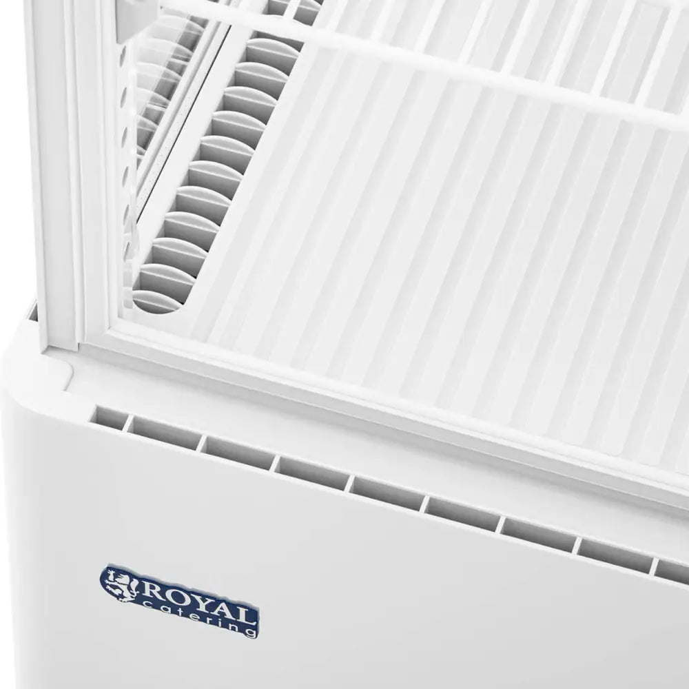 Kjølerom for eksponering, detaljvisning ovenfra av hvitt skap med rist, ventilasjonsåpninger og Royal Catering-logo.