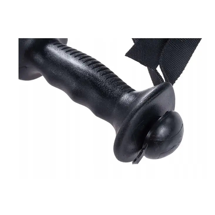 Komperdell Schnapsstock skistav, sidevisning av sort plastgrep med ergonomiske riller og synlig håndstropp.