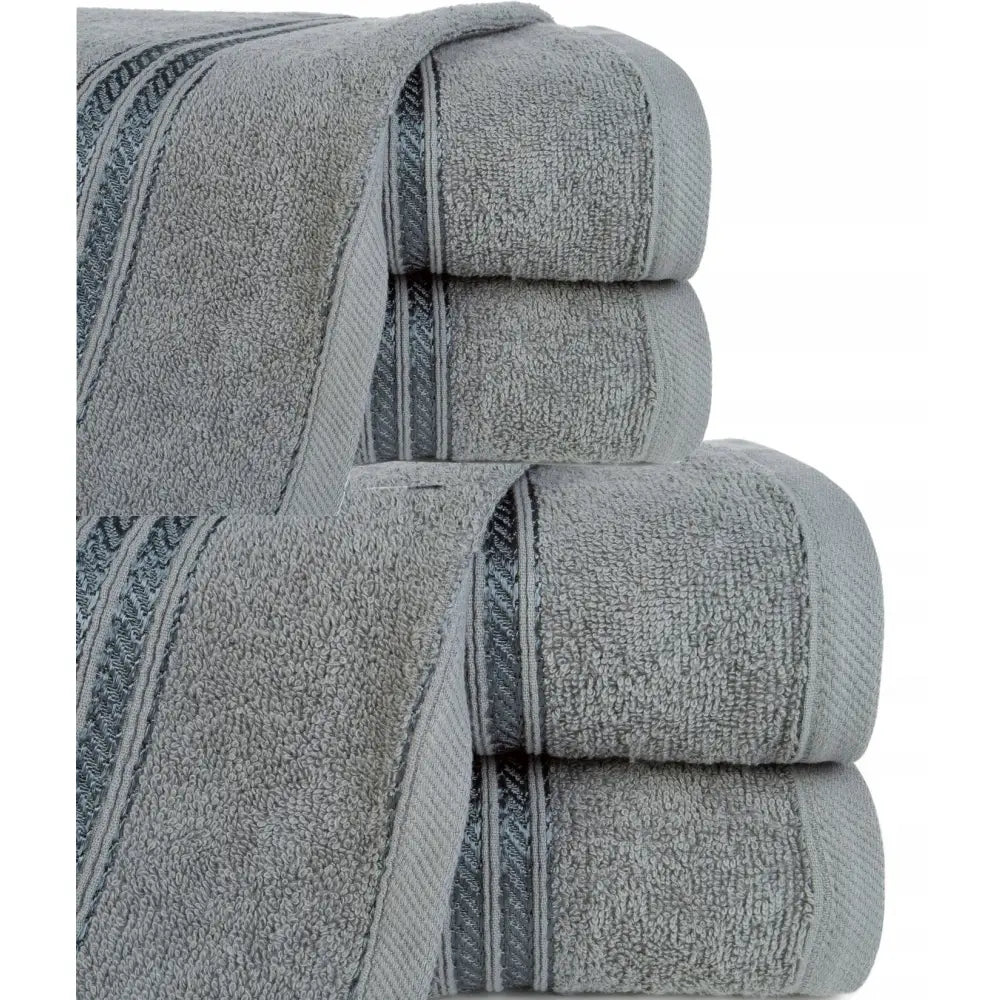 Komplett sett med fire grå bomullshåndklær, stablet fra siden med dekorative striper og frottéstruktur.