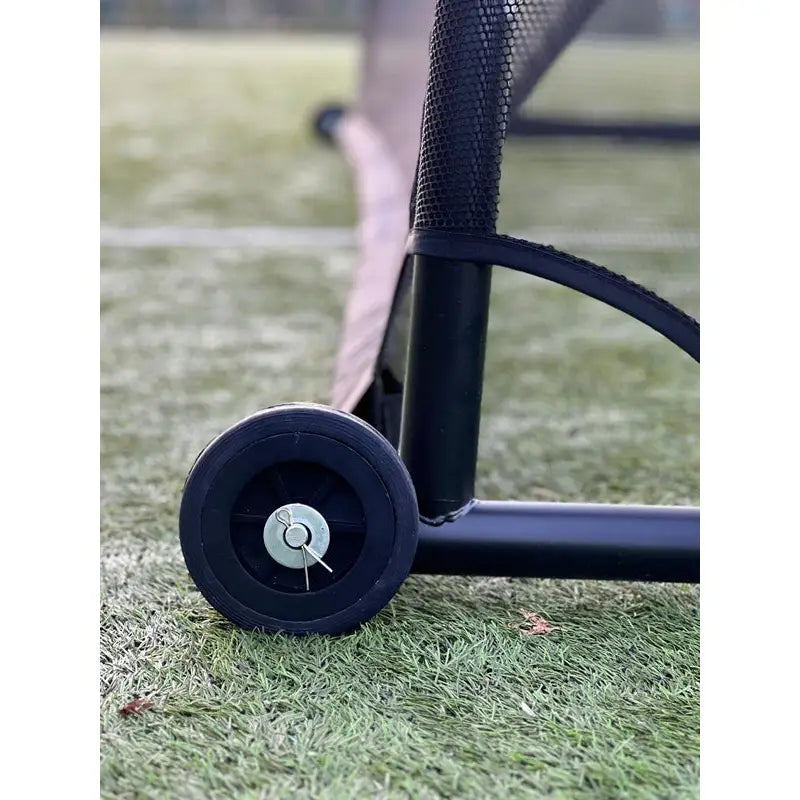 Mål Fotballmål GIZA, detaljert visning av sort hjul montert på metallramme med netting på kunstgress.