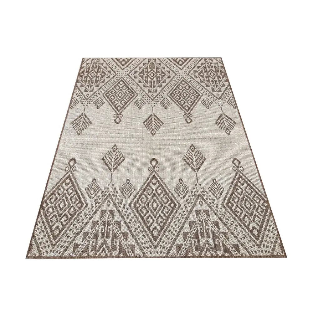 Dobbeltsidig Zara 13 teppe i beige og brunt, sett ovenfra med diamant- og pilmønster i vevd materiale.