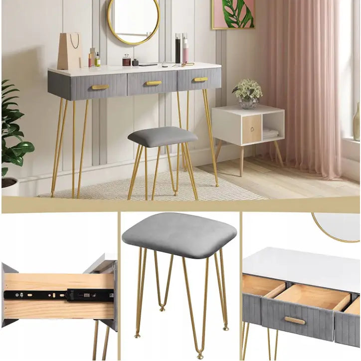 Moderne sminkebord med hvit topp, grå skuffer, speil og krakk med grå pute, fokus på gulldetaljer og strømuttak.