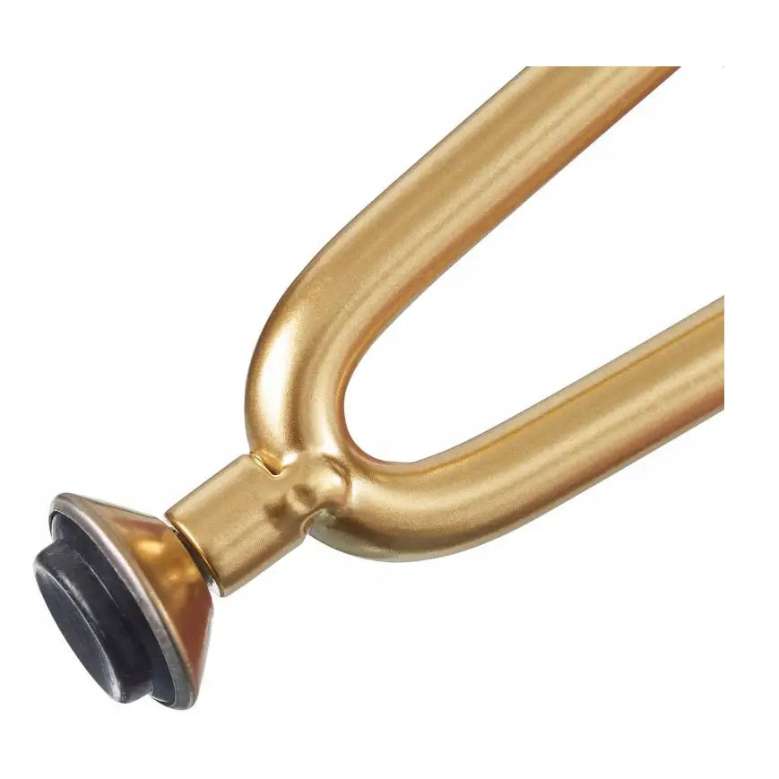 Sminkebord, nærbilde av gyllent metallben med gummiert ende, fokus på detaljene i endestykket.