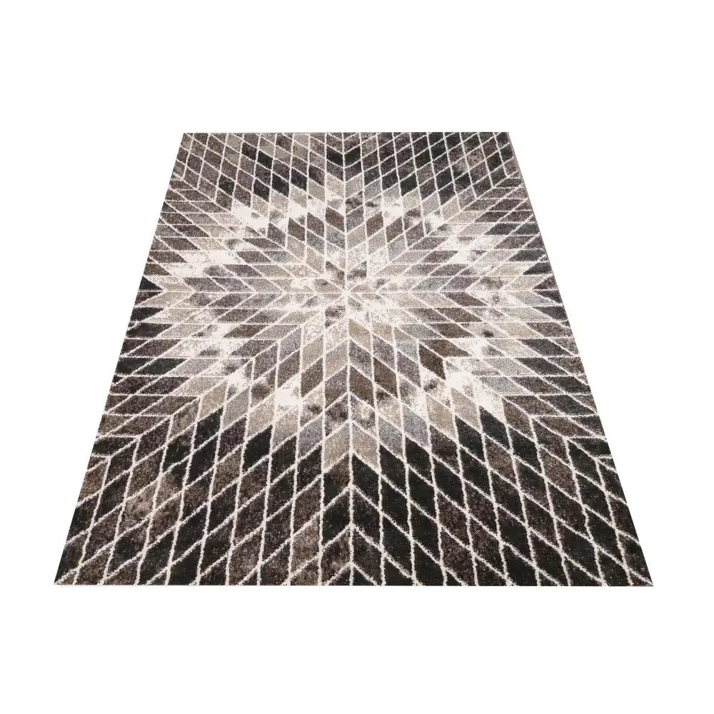 Panamero 10 brun teppe 120x170 cm, sett ovenfra med grått, hvitt og sort stjernemønster i 3D-effekt.