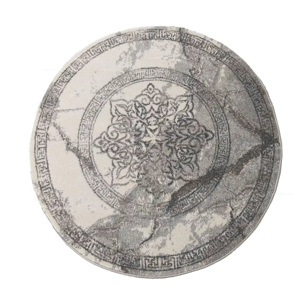 Modernt Tepe Vista 04, rundt teppe i gråtoner med orientalsk mønster, dekorativ bord og sentral rosett.