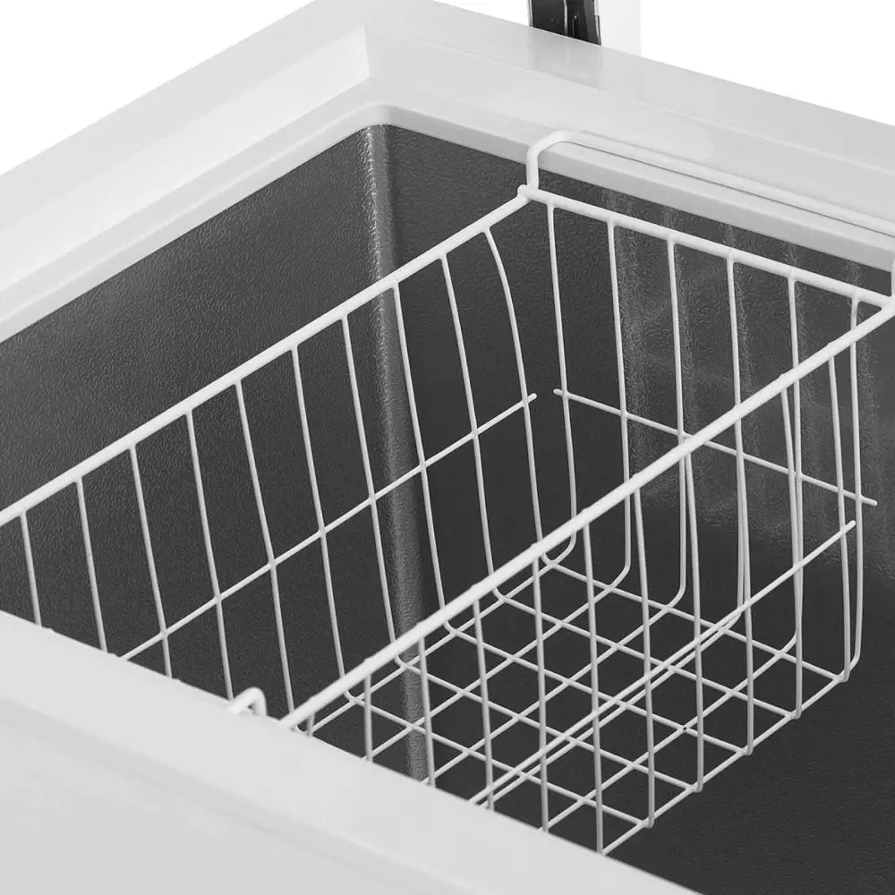 Nøkkellåst fryseboks 242L, metallkurv med rutenett sett skrått ovenfra i sort kjølerom.