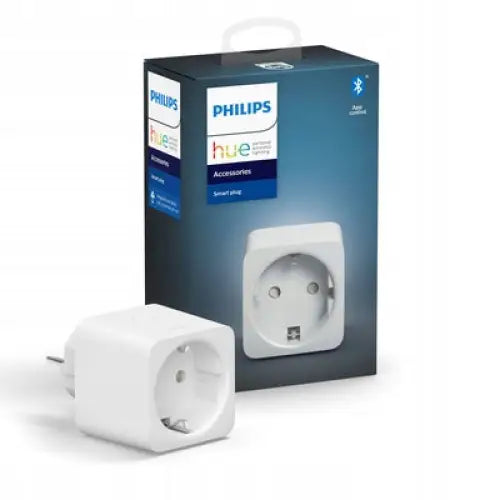 Philips Hue smartplugg med avrundede kanter, vist skrått foran med original emballasje synlig bak.