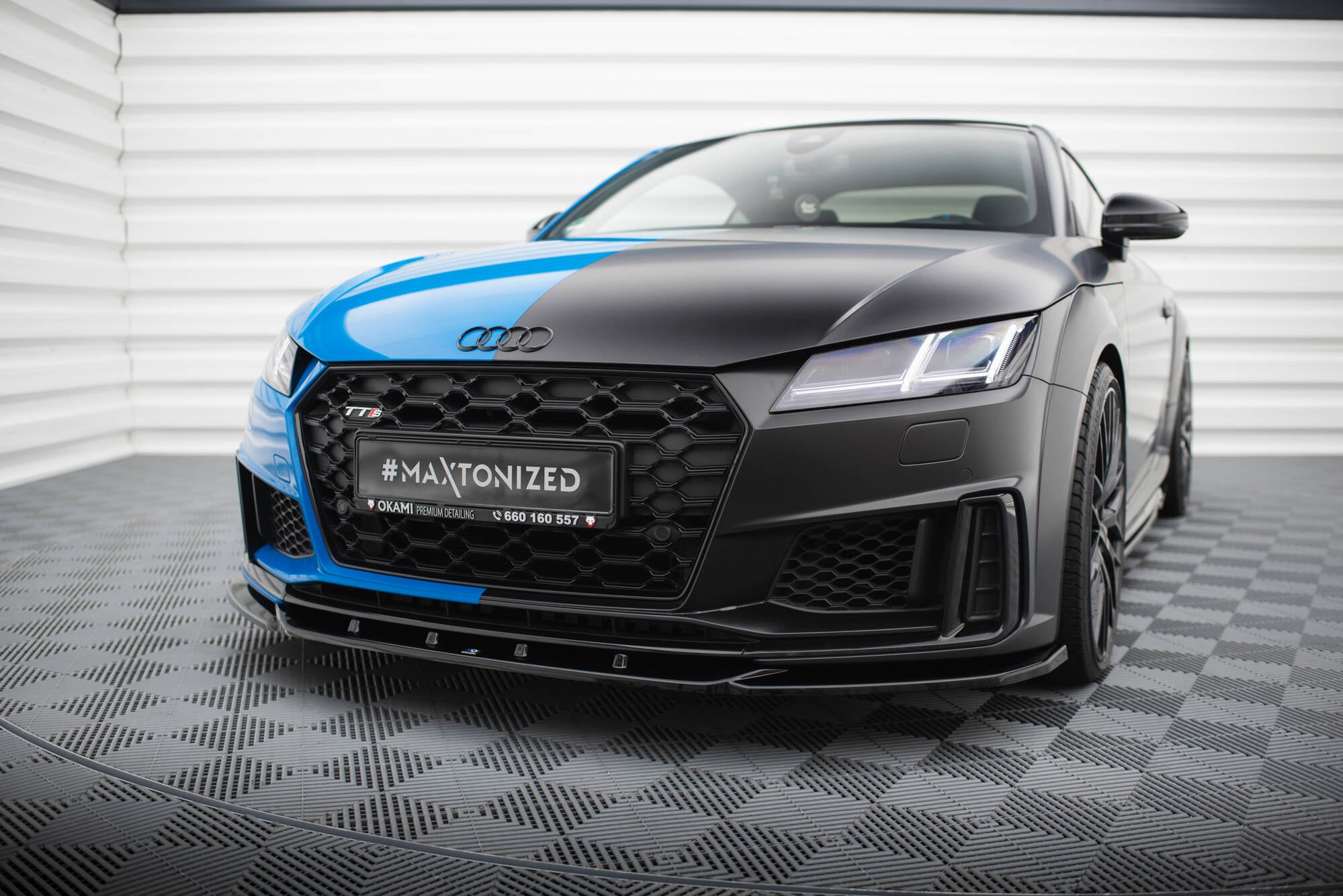 Frontspoiler Audi TT S Facelift V.2 montert på blå sportsbil med sorte detaljer og aggressive luftinntak.