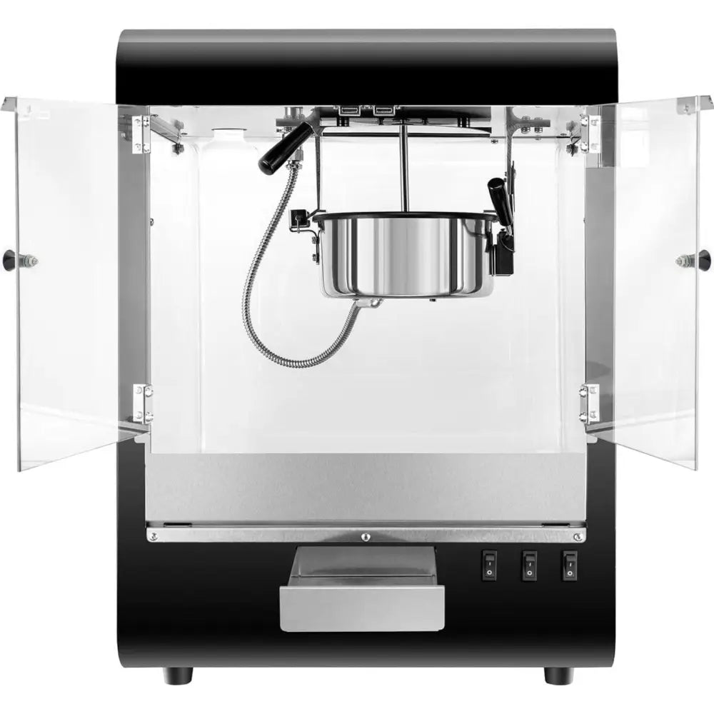 Poppemaskin i svart med blank stålkjele, doble glassdører og synlige kontrollbrytere foran.