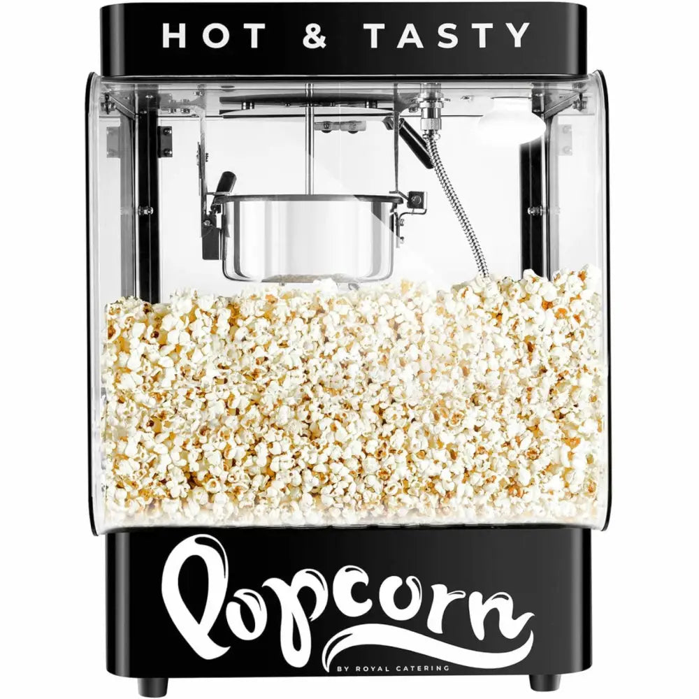 Svart popcornmaskin i glass og metall, frontvisning med ferdig poppede popcorn og "HOT & TASTY" på toppen.