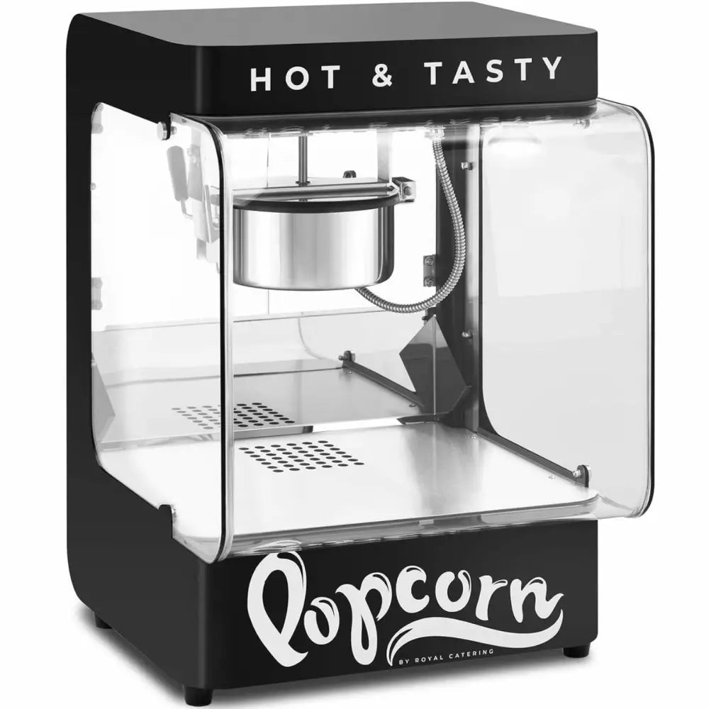 Svart popcornmaskin med teksten "HOT & TASTY", synlig rustfri kjele og gjennomsiktige sider, skrå vinkel.