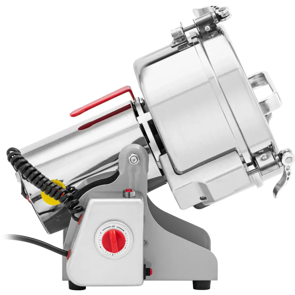 Elektrisk krydderurte- og kaffekvern i rustfritt stål, sidevisning med rødt justeringshjul og spiralformet kabel.