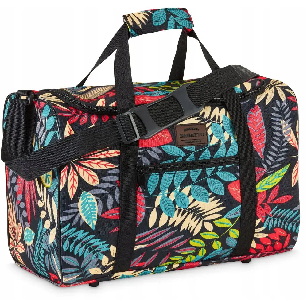 Reiseveske med bladmotiv i sterke farger, sort bunn, sorte stropper og justerbar skulderrem, skrå vinkel.