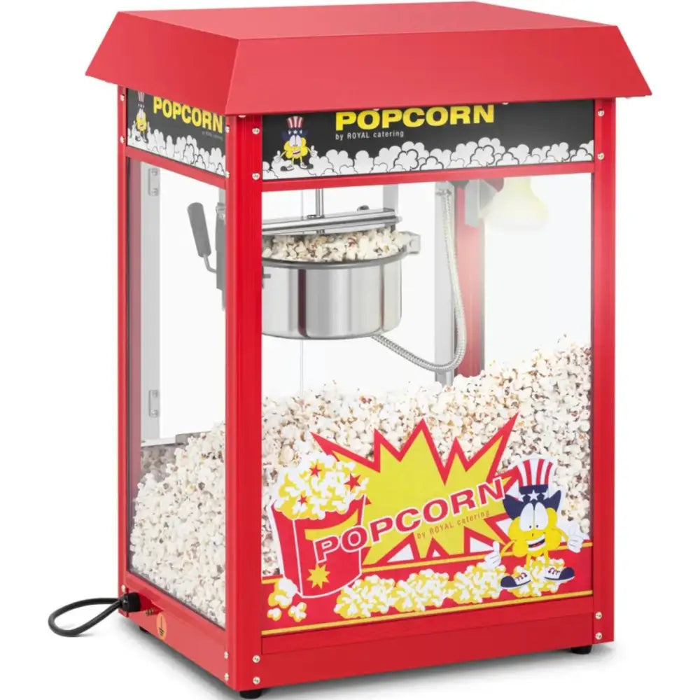 Retro popcornmaskin i rødt metall og glass, skrå frontvisning med ferskt popcorn og fargerike detaljer.
