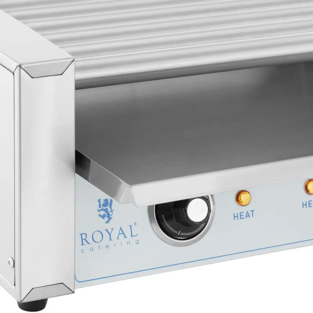 Rullegrill for pølser, nærbilde av ribbet stålflate, kontrollbryter og opplyste indikatorlamper på fronten.