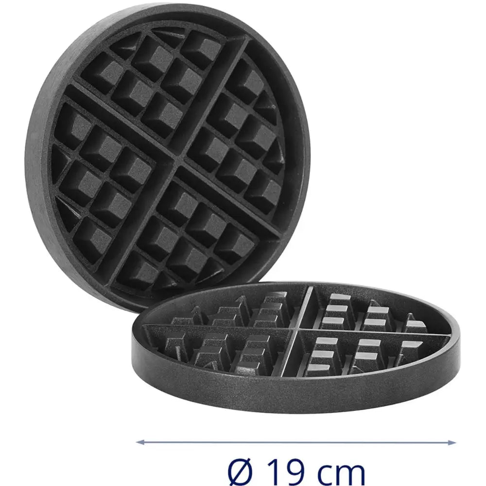 Runde varmeplater for sirkelvafler, to svarte metallplater med rutemønster sett fra skrå vinkel.