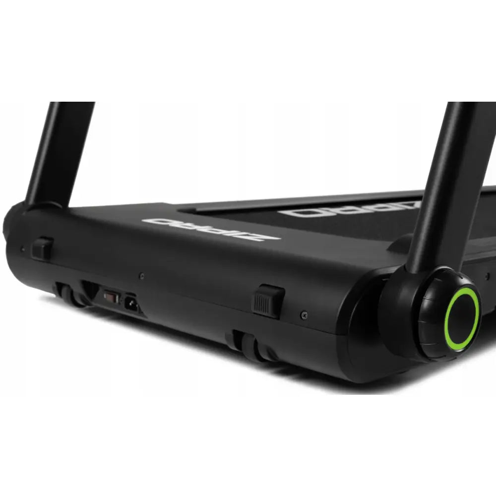 Sammenleggbar Tredemølle Zipro Jogger, nærbilde av hjul med grønn ring og justeringshjul på lyst gulv.