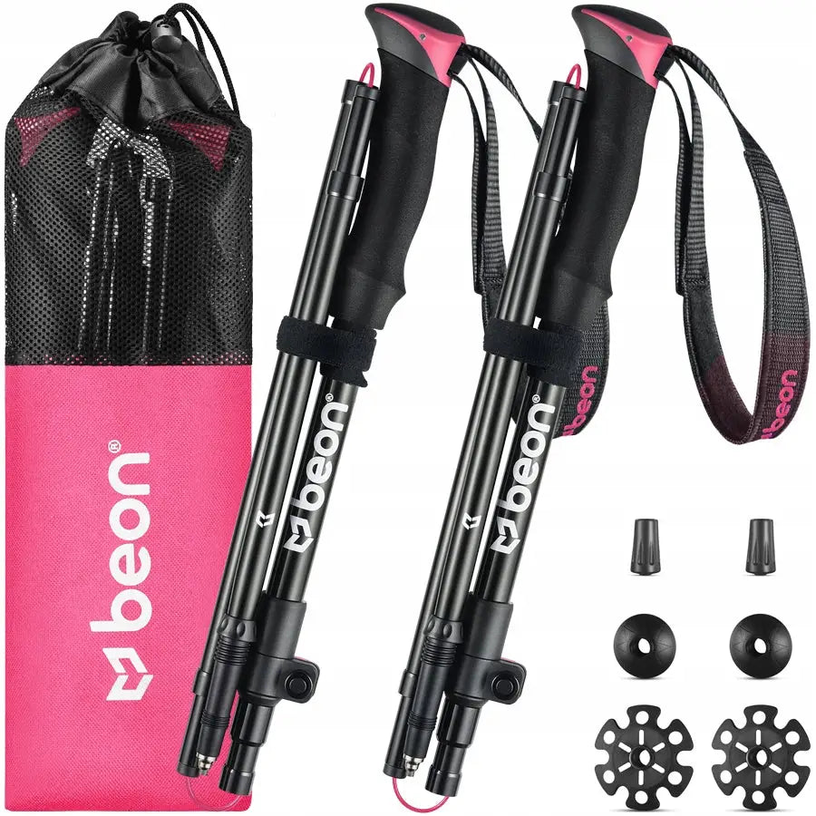 Sammenleggbare trekkingstaver i svart med rosa detaljer, håndstropper, rosa pose og ekstra trinser og gummiføtter.