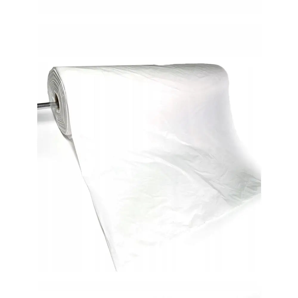 Setetrekk på rull, gjennomsiktig plastfolie med glatt, skinnende overflate utrullet mot høyre.