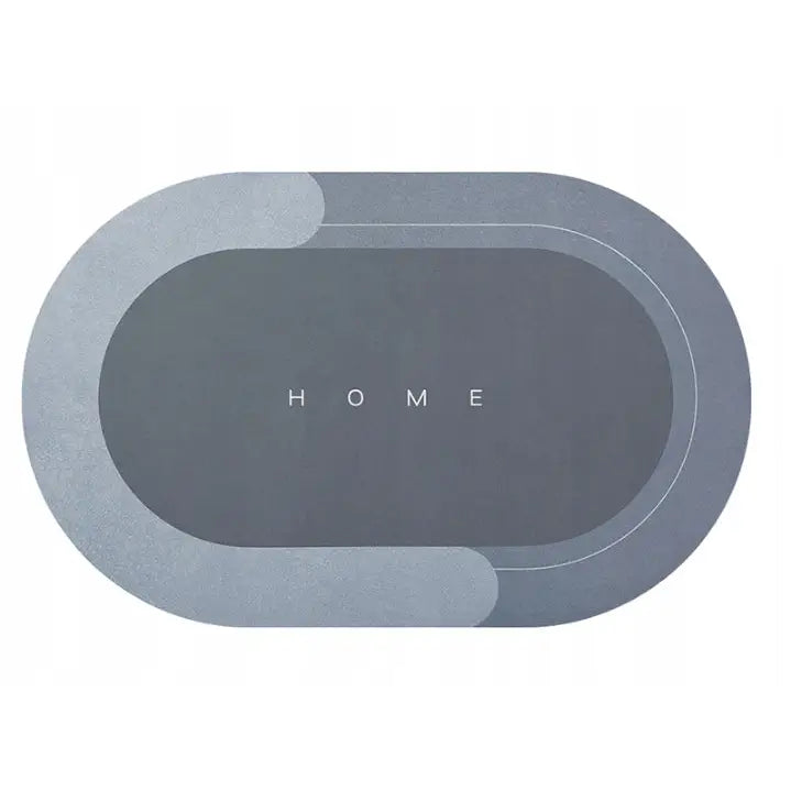 Skliresikker badematte i grått, oval form med lysegrå buer og teksten HOME sentrert på hvit bakgrunn.