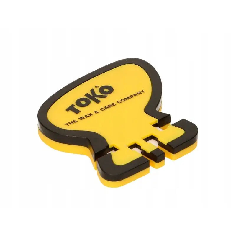 Slipemaskin for langrennski fra Toko, gul og svart modell sett skrått ovenfra med synlig logo og åpninger.