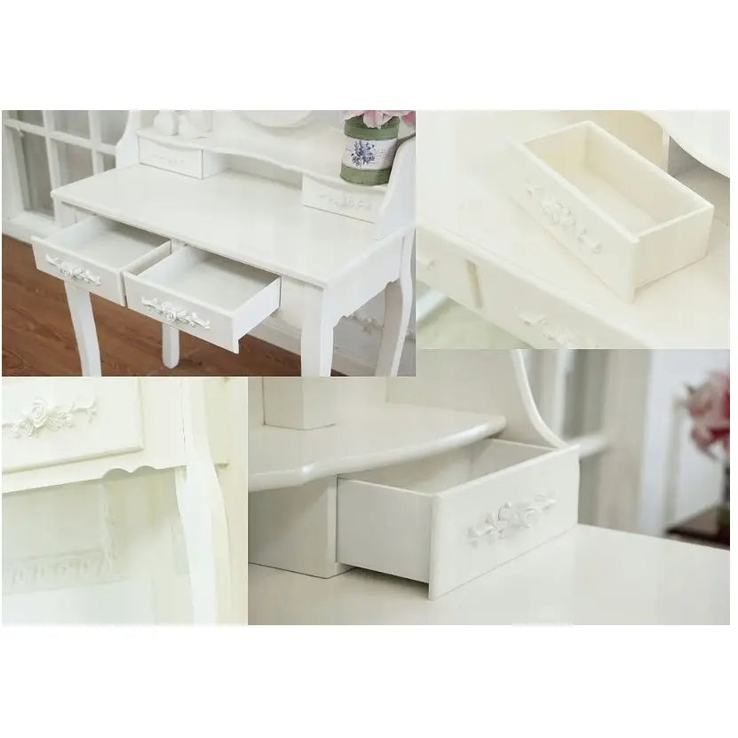 Sminkebord med LED-speil, detaljert nærbilde av åpne skuffer og utskårne blomsterdekor på hvitt treverk.