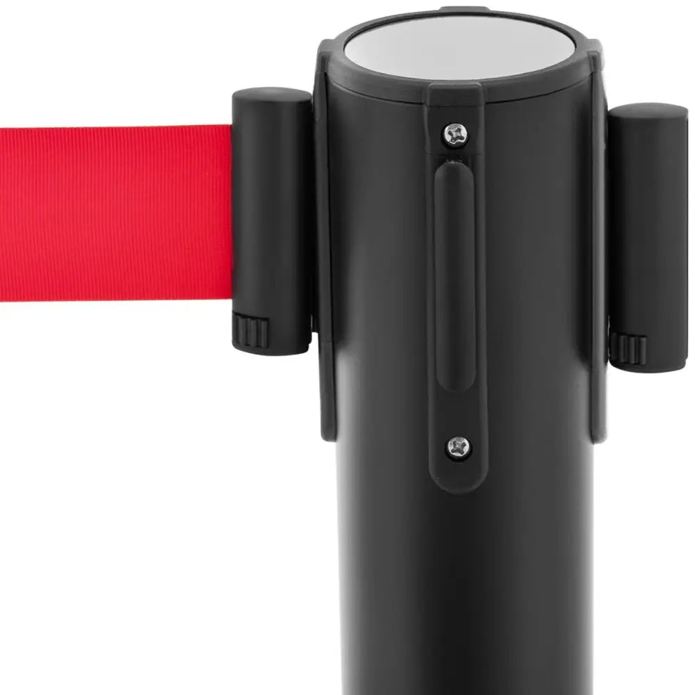 Sort stolpe med sylinderform, rødt uttrekkbart bånd til venstre og to svarte fester synlig forfra.