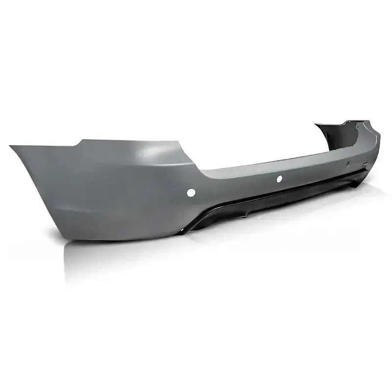 Bakfanger Bmw E61 Touring M-Pack PDC i grå plast med sorte detaljer og sirkulære hull sett bakfra.