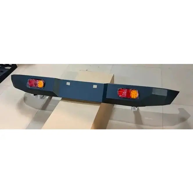 Bakfanger Suzuki Jimny 18- i mørk grått metall med integrerte røde og oransje baklys, sett skrått ovenfra.