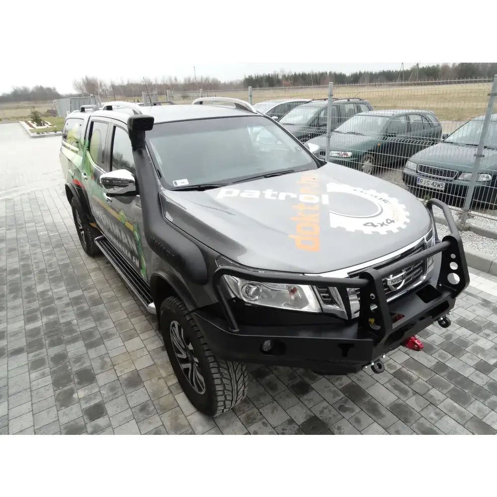 Front bumper på Nissan Navara D23 med svart bullbar, snorkel og grafisk dekor på panseret.