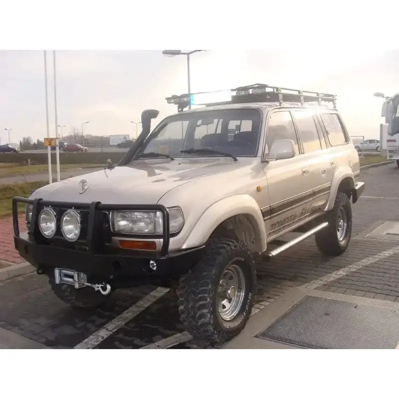 Frontfanger på Toyota Land Cruiser LC80 med bullbar, vinsj, ekstralys og grove terrengdekk.