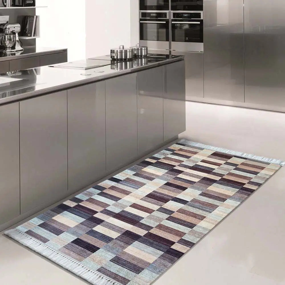 Tepe Blanka teppe i brun, beige og lyseblått rutemønster på lyst kjøkkengulv ved grå kjøkkenfronter.